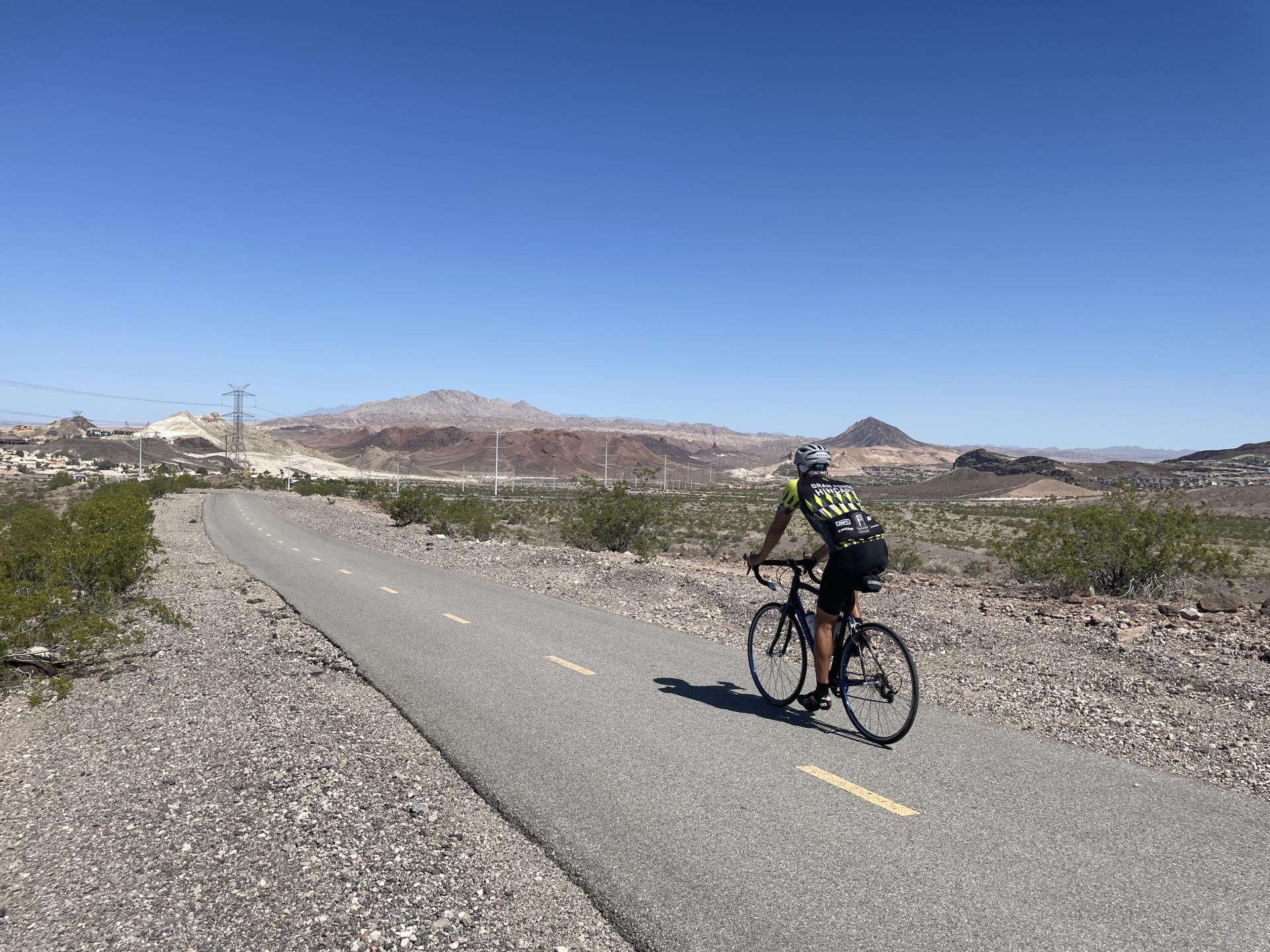 bicyclist riding on trail in desert