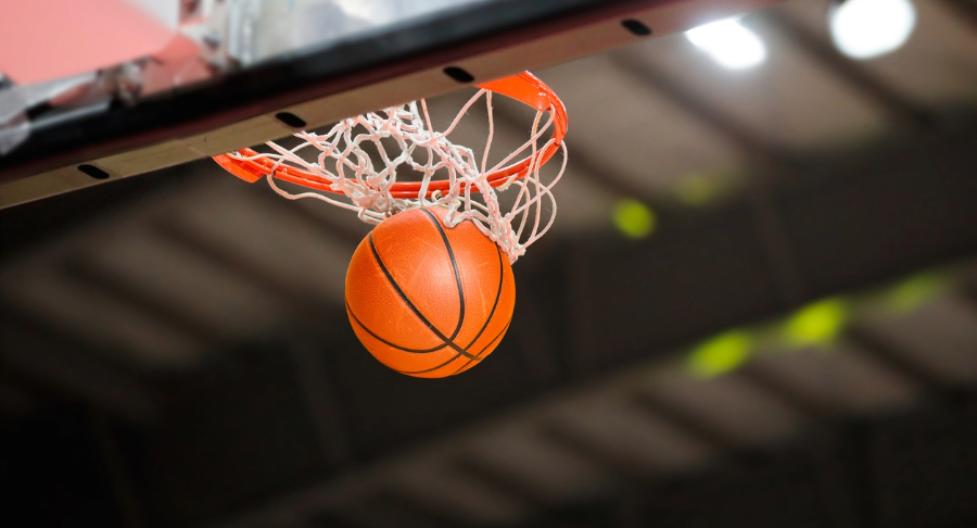 Basketball falling through hoop.